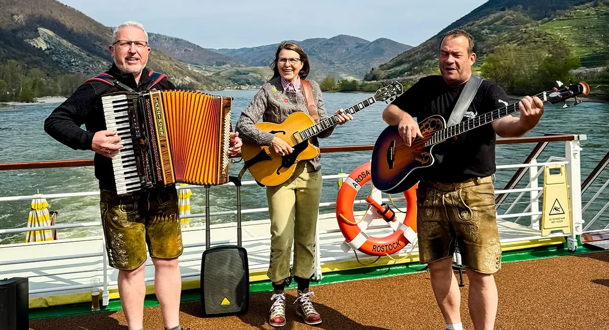 Vollblutmusiker von KaBeGl mit Akkordeon und Gitarren auf dem Sonnendeck bei einer Flusskreuzfahrt auf der Donau
