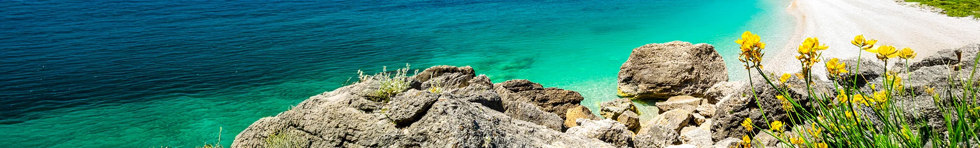 Türkisblaues Wasser an der Adriaküste in Albanien mit Blick auf Strand und Küstenlandschaft